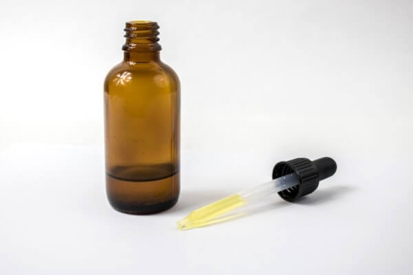 Castor oil in amber-glass bottle