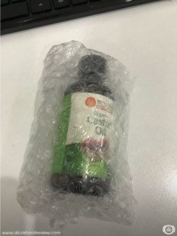 A bottle of Inesscents castor oil covered in bubble wrap